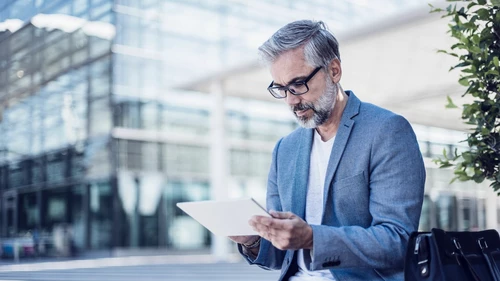 Businessman using tablet outdoors